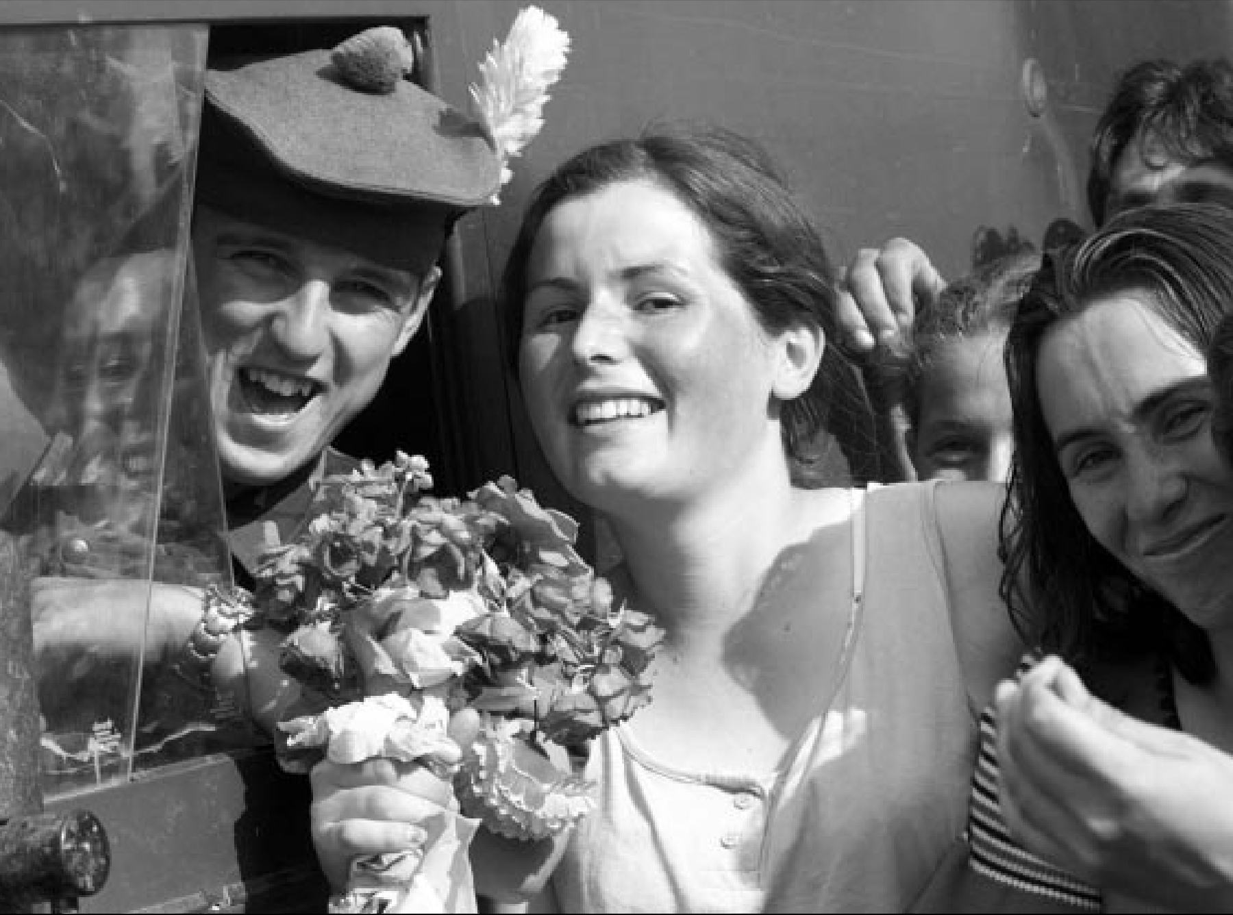 KFOR troops entering Kosovo in June 1999 are greeted with flowers.